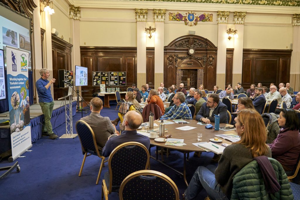 A speaker presents to a full room about the Hull and East Yorkshire Local Nature Recovery Strategy